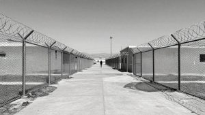 California immigration detention center exterior with fences.
